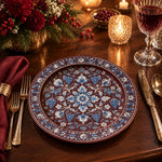 Burgundy charger plate featuring blue and white floral garland around a blossom medallion