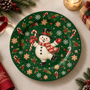 Green charger plate with gold trim featuring a snowman among candy canes and snowflakes