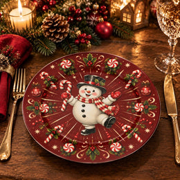 Red charger plate with gold trim featuring a snowman between radiating candy canes and snowflakes