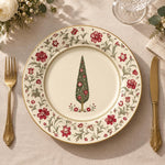 Cream charger plate with gold trim featuring a vintage tree framed by a trailing rose border