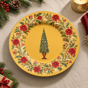 Golden charger plate with gold trim featuring a vintage tree in a wreath of red carnations