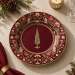Burgundy charger plate with gold trim featuring a gilded tree in a beaded medallion and blossoms
