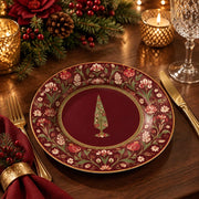 Burgundy charger plate with gold trim featuring a gilded tree in a beaded medallion and blossoms