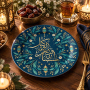 Navy blue charger plate with gold trim featuring calligraphy beside a crescent and hanging lanterns