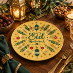 Golden charger plate with gold trim featuring Eid script among radiating leaves and a lantern