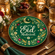 Green charger plate with gold trim featuring Eid script, crescent and lanterns among olive leaves
