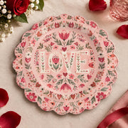 Pink scalloped plate with LOVE letters inside a folk floral wreath