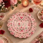 Pink scalloped plate with LOVE letters inside a folk floral wreath