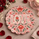 Pink scalloped plate with cream LOVE letters between coral tulips
