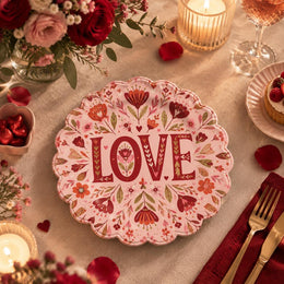 Pink scalloped plate with deep wine LOVE letters among oxblood flowers