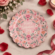 Pink scalloped plate with Valentine's Day script inside a heart wreath