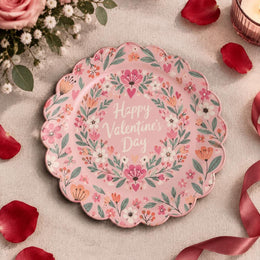 Pink scalloped plate with Valentine's Day script inside a heart wreath