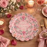 Pink scalloped plate with Valentine's Day script inside a heart wreath