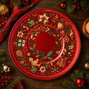 * Red Christmas charger plate with festive holiday design, top-down view.