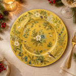 * Flat lay of a Christmas gold charger plate featuring a metallic gold base with festive holiday borders.