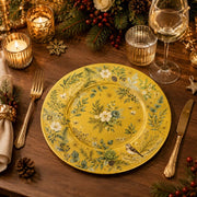 * Elegant Christmas gold charger plate set on a festive holiday dinner table decorated with candles and pine.