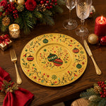* Gold Christmas under plates set on a festive holiday dinner table with candles and pine decor.