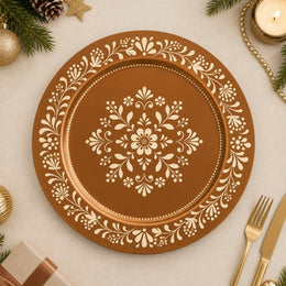 Symmetrical copper and cream folk art wedding charger plate with radiating central floral medallion design.