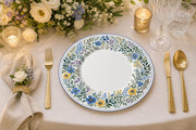 * Romantic wedding reception table setting featuring elegant white floral charger plates under chic dinnerware.