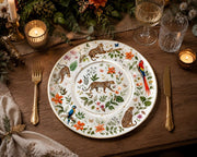 * Elegant white charger plates with gold rims arranged on a beautifully styled dining table for a modern banquet.