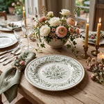 * A modern white and gold charger plate styled on a beautifully set dinner table with linen napkins and cutlery.