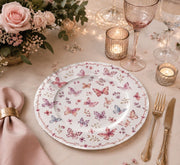 * Elegant dining table setting featuring a modern abstract white and gold charger plate styled with contemporary dinnerware.