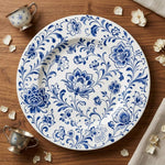 * Top-down view of a classic white charger plate featuring an elegant beaded rim on a clean background.