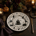 * A chic everyday dining table set with white painting charger plates under ceramic dinnerware on a textured table runner.