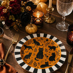 * Elegant table setting featuring white painted charger plates layered under ceramic dinnerware at a modern dinner party.