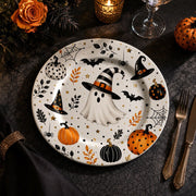 * Minimalist white charger plate with abstract black and grey paint stroke design, flat top-down view.