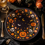 * Flat view of a dark blue Halloween decorative plate featuring a wreath of jack-o'-lanterns, skulls, and fall leaves.