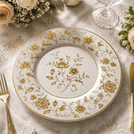 * Elegant white charger plate featuring detailed gold floral patterns and a gold rim for wedding table decor.