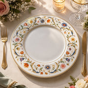 * Elegant white charger plate featuring a vintage colorful floral border with a gold rim design.