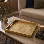 Quran Embossed Glass Serving Tray – Golden Calligraphy glass serving tray shown in a first styled room scene.