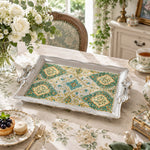 Warm ivory tray with gold trim featuring a cream medallion of blossoms inside a fine gold keyline