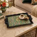 Black tray with gold trim featuring teal and gold florals carpeting a black ground