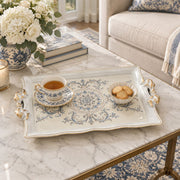 Ivory white tray with gold trim featuring a blue rosette medallion and acanthus scrolls