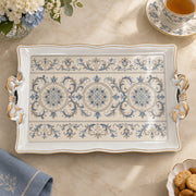Ivory white tray with gold trim featuring three blue rosette medallions in a row