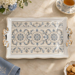 Ivory white tray with gold trim featuring three blue rosette medallions in a row