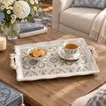 Ivory white tray with gold trim featuring three blue rosette medallions in a row