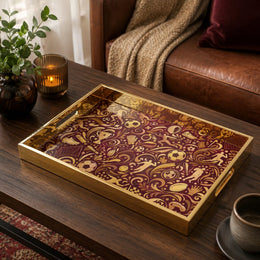 Sports Heritage Glass Serving Tray – Burgundy Gold Icons on a coffee table, featuring UV-printed artwork on tempered glass with an electroplated frame and matching handles.
