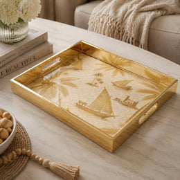 Gulf Coastline Glass Serving Tray – Palm Trees & Sailboats on a coffee table, featuring UV-printed artwork on tempered glass with an electroplated frame and matching handles.