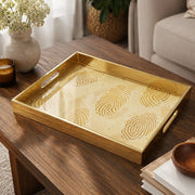 Fingerprint Art Glass Serving Tray – Gold Topographic on a coffee table, featuring UV-printed artwork on tempered glass with an electroplated frame and matching handles.