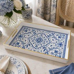 White tray with gold trim featuring blue and white Delft-inspired floral medallion pattern