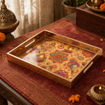 Diwali Paisley Mandala Tray with Diyas - Gold Frame - Minti Home on a coffee table, featuring UV-printed artwork on tempered glass with an electroplated frame and matching handles.