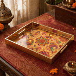 Diwali Paisley Mandala Tray with Diyas - Gold Frame - Minti Home on a coffee table, featuring UV-printed artwork on tempered glass with an electroplated frame and matching handles.