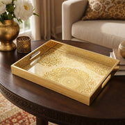 Mandala Glass Serving Tray – Cream Gold Lace Pattern on a coffee table, featuring UV-printed artwork on tempered glass with an electroplated frame and matching handles.