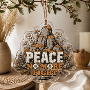Clear acrylic wall decor showing a stone cairn wrapped in daisies with Peace and No More Fight lettering.
