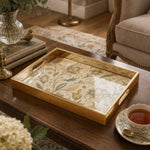 Persian Floral Decorative Tray with Gold Frame and Paisley Motifs | Minti Home on a coffee table, featuring UV-printed artwork on tempered glass with an electroplated frame and matching handles.
