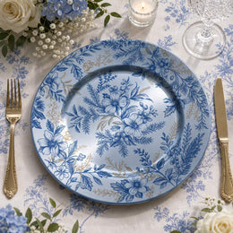 Blue and white toile floral pattern of hibiscus and berries on a round blue decorative charger plate with gold scroll rim for garden party table decor.

Plate type: electroplated (blue)